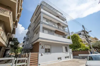 an apartment building with a white facade at Raise Kifisias Serviced Apartments in Athens
