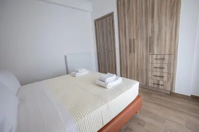 a bedroom with a bed with two towels on it at Raise Kifisias Serviced Apartments in Athens
