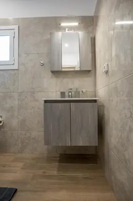a bathroom with a sink and a mirror at Raise Kifisias Serviced Apartments in Athens