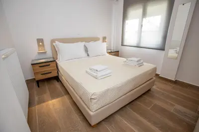 a bedroom with a bed with two towels on it at Raise Kifisias Serviced Apartments in Athens
