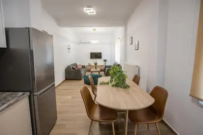 a kitchen and dining room with a table and chairs at Raise Kifisias Serviced Apartments in Athens