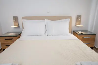 a bedroom with a bed with two night stands and two lamps at Raise Kifisias Serviced Apartments in Athens