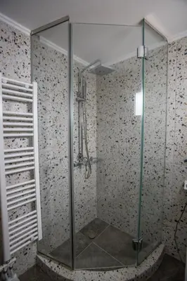 a shower with a glass door in a bathroom at Raise Kifisias Serviced Apartments in Athens