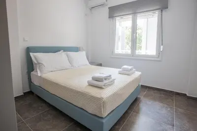 a bedroom with a bed with towels on it at Raise Kifisias Serviced Apartments in Athens