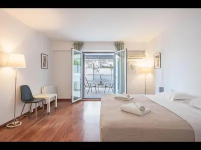 a bedroom with a bed and a table and chairs at Adelos III Bloom Villa 5BR 360m - Sauna - Rooftop in Athens