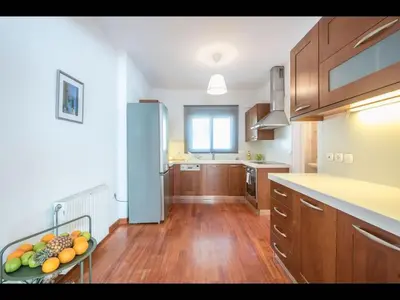 a kitchen with a table with a bowl of fruit on it at Adelos III Bloom Villa 5BR 360m - Sauna - Rooftop in Athens