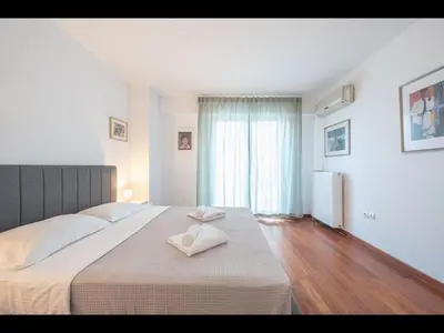 a bedroom with a large bed with two towels on it at Adelos III Bloom Villa 5BR 360m - Sauna - Rooftop in Athens