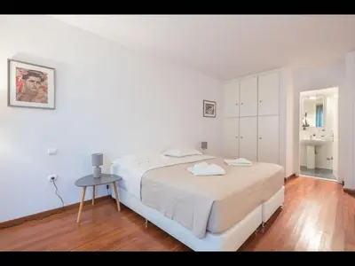 a white bedroom with a bed and a table at Adelos III Bloom Villa 5BR 360m - Sauna - Rooftop in Athens