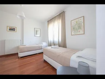 a hotel room with two beds and a window at Adelos III Bloom Villa 5BR 360m - Sauna - Rooftop in Athens
