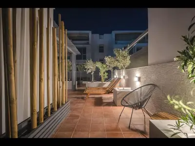a patio with chairs and tables on a building at Adelos III Bloom Villa 5BR 360m - Sauna - Rooftop in Athens