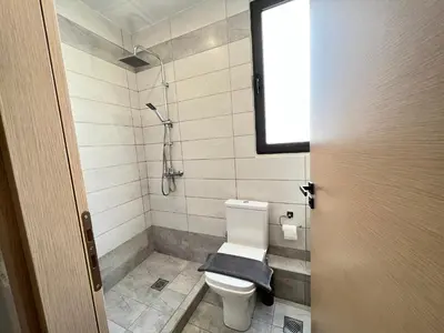 a bathroom with a toilet with a towel on it at Navitas House in Athens