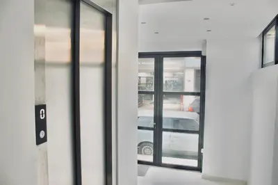 a door to a building with a car outside at Navitas House in Athens