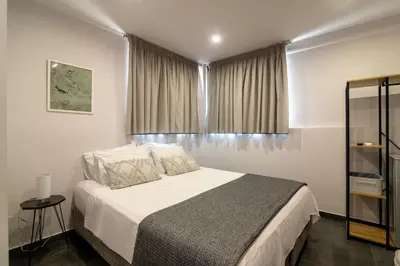 a bedroom with a large bed and a window at Navitas House in Athens