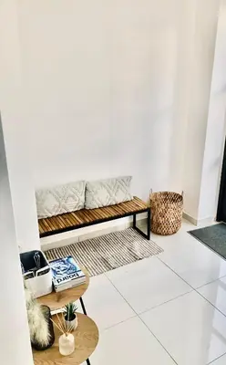 a living room with a bench and tables at Navitas House in Athens