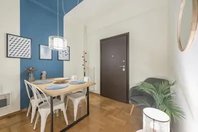 a dining room with a table and chairs at City Suite by Cloudkeys in Athens