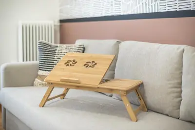 a wooden coffee table sitting on a couch at City Suite by Cloudkeys in Athens