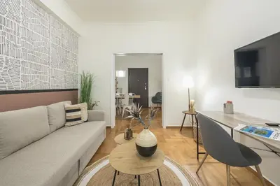 a living room with a couch and a table at City Suite by Cloudkeys in Athens