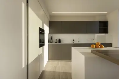 a kitchen with white cabinets and oranges on a counter at Über Lux 2 BR New Penthouse with Acropolis View in Athens