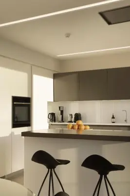 a kitchen with two black stools in a kitchen at Über Lux 2 BR New Penthouse with Acropolis View in Athens