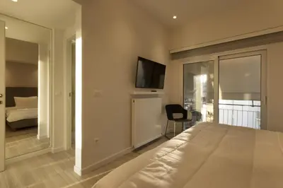 a bedroom with a bed and a tv on the wall at Über Lux 2 BR New Penthouse with Acropolis View in Athens