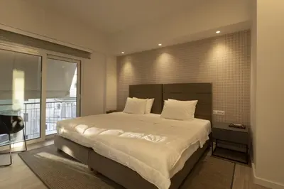 a bedroom with a large bed and a large window at Über Lux 2 BR New Penthouse with Acropolis View in Athens
