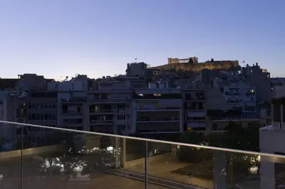 a view of a city from the balcony of a building at Über Lux 2 BR New Penthouse with Acropolis View in Athens