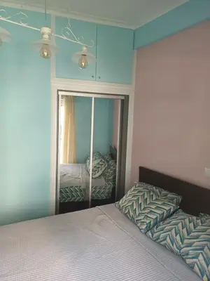 a bedroom with a bed and a mirror at Evangelli Apartment- An oasis inside the center of Athens in Athens