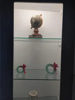 a glass shelf with a globe on top of it at Evangelli Apartment- An oasis inside the center of Athens in Athens