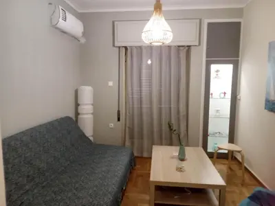 a small room with a bed and a table at Evangelli Apartment- An oasis inside the center of Athens in Athens