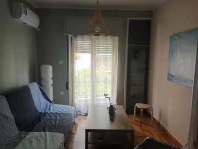 a living room with a couch and a table at Evangelli Apartment- An oasis inside the center of Athens in Athens