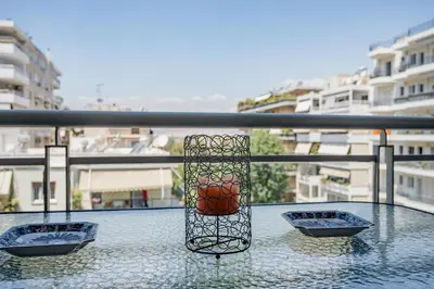 three bowls sitting on a glass table on a balcony at Flat w Parking at Flisvos Marina & SNFCC, 300mbps in Athens