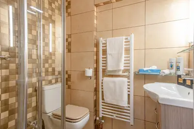 a bathroom with a toilet and a sink at Flat w Parking at Flisvos Marina & SNFCC, 300mbps in Athens