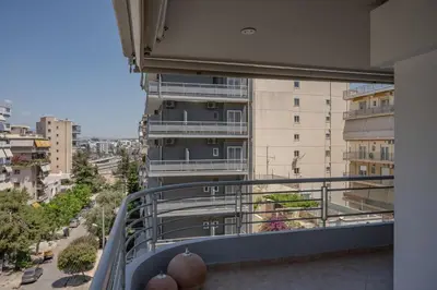 an apartment balcony with a view of a city at Flat w Parking at Flisvos Marina & SNFCC, 300mbps in Athens