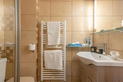 a bathroom with a sink and a toilet and a shower at Flat w Parking at Flisvos Marina & SNFCC, 300mbps in Athens