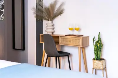a bedroom with a desk with two glasses of wine at PAME Wild in Athens
