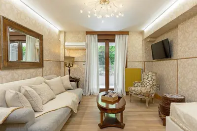 a living room with a couch and a table at Vouliagmeni's Elegance by Acropolis Suites in Athens