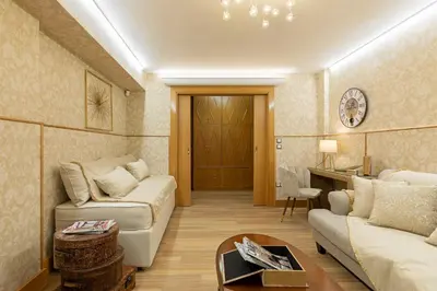a living room with a couch and a table at Vouliagmeni's Elegance by Acropolis Suites in Athens