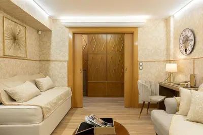 a living room with a couch and a table at Vouliagmeni's Elegance by Acropolis Suites in Athens