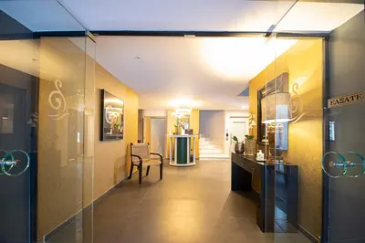 a hallway with a table and a chair in a room at FALIREON HOTEL in Athens
