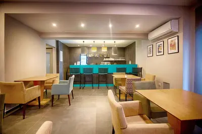 a restaurant with tables and chairs and a bar at FALIREON HOTEL in Athens