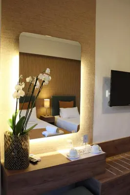 a hotel room with a bed and a large mirror at FALIREON HOTEL in Athens
