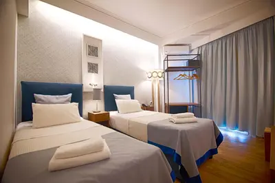 a hotel room with two beds with towels on them at FALIREON HOTEL in Athens