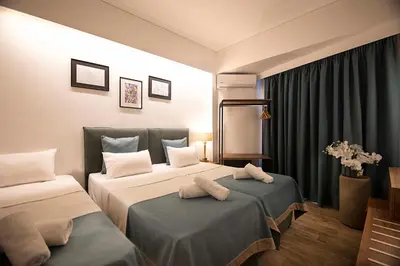 a hotel room with two beds and a window at FALIREON HOTEL in Athens