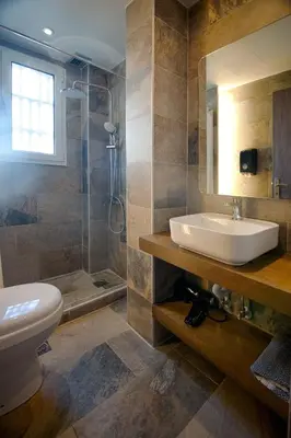 a bathroom with a sink and a toilet and a shower at FALIREON HOTEL in Athens