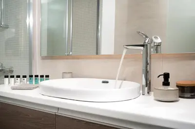 a sink with a faucet on a bathroom counter at Blue Avra Apartment by A&D Properties in Porto Rafti