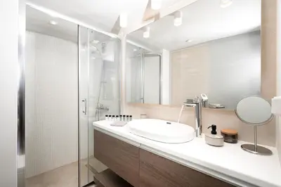 a bathroom with a sink and a shower at Blue Avra Apartment by A&D Properties in Porto Rafti