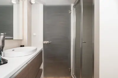 a bathroom with a shower and a sink at Blue Avra Apartment by A&D Properties in Porto Rafti