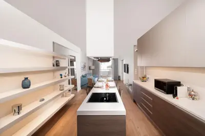 a kitchen with white cabinets and a sink at Blue Avra Apartment by A&D Properties in Porto Rafti