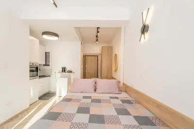a living room with a bed and a kitchen at Lovely studio 1' from Attiki metro station in Athens