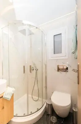 a bathroom with a shower and a toilet at Lovely studio 1' from Attiki metro station in Athens